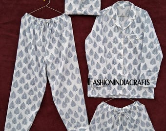 May include: A white pajama set with a blue leaf pattern, including pants, a button-down shirt, and shorts. The set also includes a matching drawstring bag. The text "FASHIONINDIACRAFTS" is visible on the shirt.
