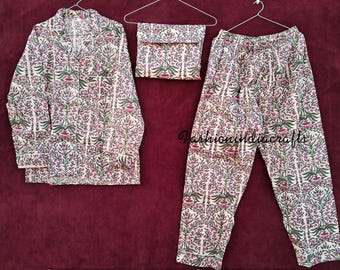 May include: A white pajama set with a floral print. The set includes a long-sleeved shirt with a button-up front and matching pants.