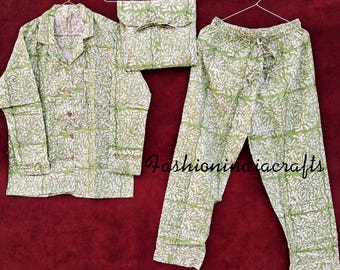 May include: A green and white patterned pajama set with a long-sleeved shirt and pants. The set includes a matching pouch.