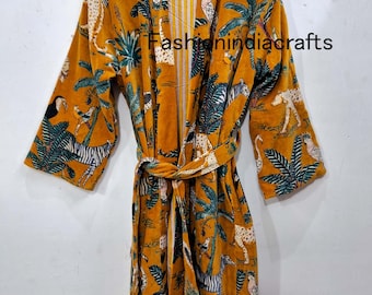 May include: Mustard-colored robe with a jungle animal print, including zebras, leopards, and parrots, and palm trees. The robe has a matching belt and is hanging on a wooden hanger. The text "Fashionindiacrafts" is visible.