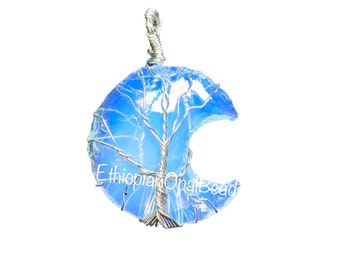 May include: A crescent moon shaped pendant with a wire wrapped tree design inside. The pendant is made of blue opal and silver wire. The text "Ethiopian Opal Bead" is visible at the bottom of the pendant.