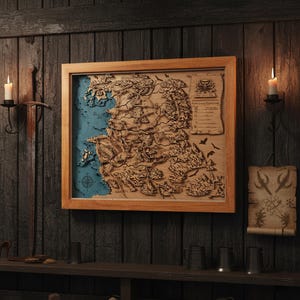 May include: A framed wooden map with intricate laser-cut details. The map features a blue ocean and a detailed depiction of landmasses. The frame is a light brown color, and the map is mounted on a dark wooden wall. The overall theme is fantasy or historical.