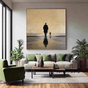 May include: A large square painting depicts a person walking a dog on a wet street. The person is in a black coat and hat, with the dog on a leash. The scene is reflected in the water, set against a muted yellow background.