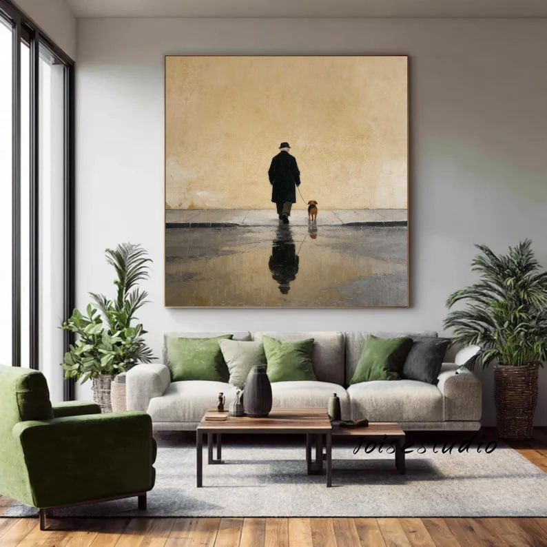 May include: A large square painting depicts a person walking a dog on a wet street. The person is in a black coat and hat, with the dog on a leash. The scene is reflected in the water, set against a muted yellow background.