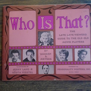 May include: Vintage book cover titled "Who Is That?" in pink and brown tones. The cover features portraits of classic movie stars and the text "The Late Late Viewers Guide to the Old Old Movie Players."