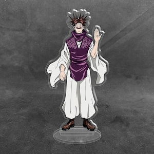May include: A clear acrylic standee featuring a character with spiky dark hair, wearing a purple sleeveless tunic over a white long-sleeved garment and white trousers. The character has a serious expression, dark markings on the face, and brown boots.