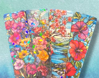 May include: Set of four colorful bookmarks featuring stained glass style floral designs. The bookmarks are rectangular and have a glossy finish.