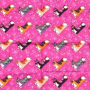 May include: Two pink fabric squares with a repeating pattern of cartoon corgis. The corgis are in various colors and poses. The larger square is approximately 18 inches by 18 inches. The smaller square is approximately 12 inches by 12 inches. The squares are on a gray surface. ELIBENIK.COM is printed in the upper right corner of the image.