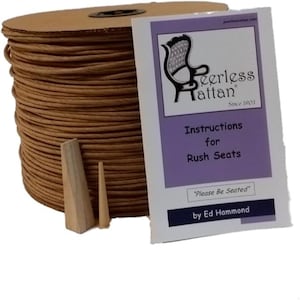 May include: A spool of brown rattan reed, two wooden tools, and a booklet titled "Instructions for Rush Seats" by Ed Hammond. The booklet features a chair illustration and the text "Peerless Rattan Since 1903".