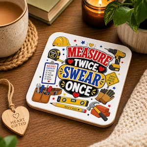 May include: A square coaster with a white background featuring the text "MEASURE TWICE, SWEAR ONCE" in red and blue. Illustrations include a yellow hard hat, tape measure, drill, tool belt, level, pencil, hammer, bricks, and a builder's checklist.