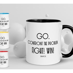 May include: White ceramic coffee mug with a black rim and handle. The mug has black text that reads "GO. CONFRONT THE PROBLEM. FIGHT! WIN! IDNI MODE".