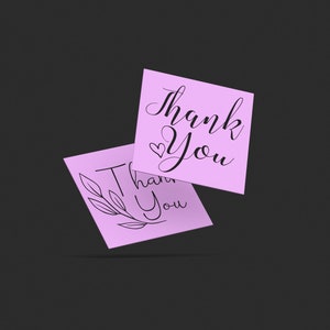 May include: Two pink thank you cards with different designs. One card has a simple handwritten thank you with a heart. The other card has a thank you with a floral design.