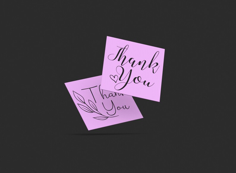 May include: Two pink thank you cards with different designs. One card has a simple handwritten thank you with a heart. The other card has a thank you with a floral design.