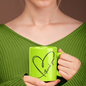 May include: A green ceramic mug with a black heart and the text "Thank you" on it.