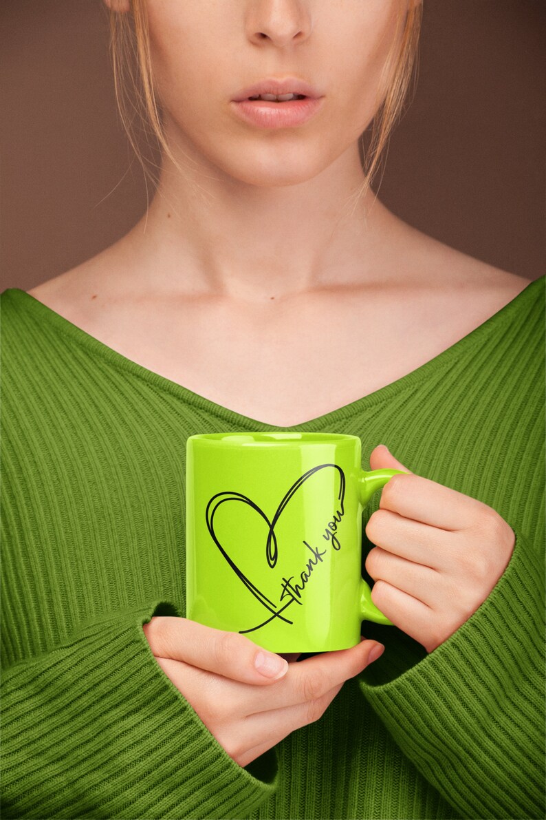 May include: A green ceramic mug with a black heart and the text "Thank you" on it.