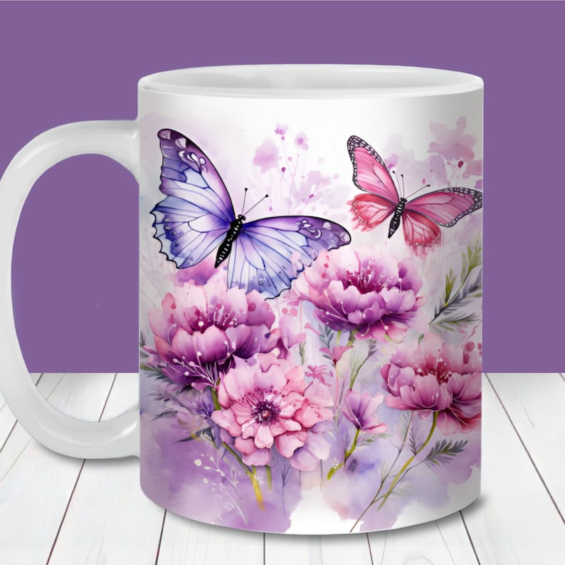 May include: White ceramic mug with a watercolor design of purple and pink flowers and butterflies. The butterflies are purple and blue and pink. The background is a light purple watercolor wash.