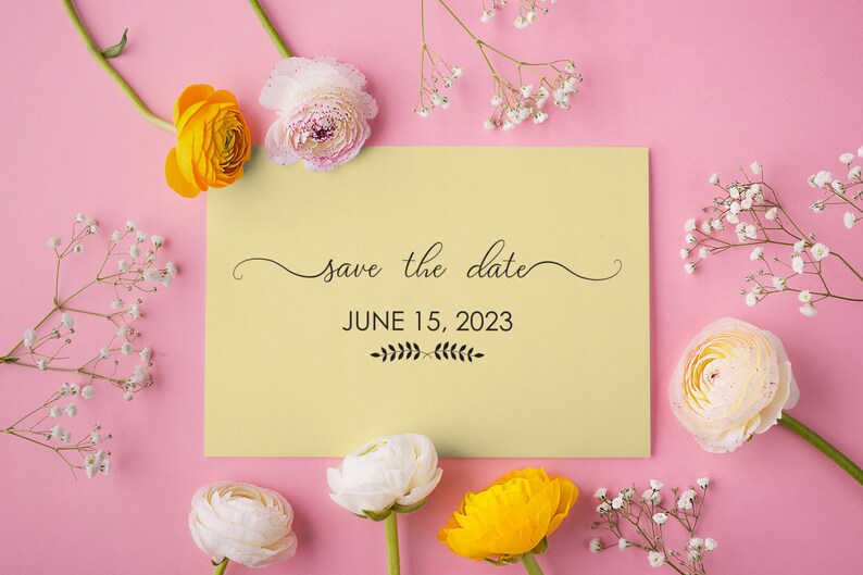 May include: A yellow and white save the date card with the text "save the date" and "JUNE 15, 2023" surrounded by white and yellow flowers on a pink background.