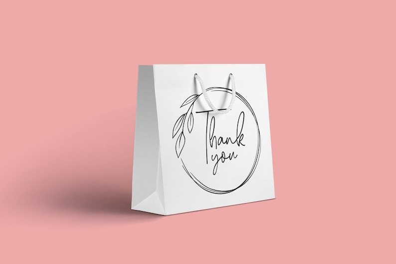 May include: White paper gift bag with a black and white circle design featuring a floral motif and the text "Thank you".