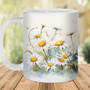 May include: White ceramic mug with a watercolor design of white daisies with yellow centers on a light blue background.
