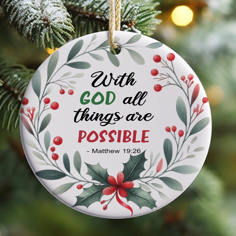 May include: White round Christmas bauble with a green wreath design and red berries. The bauble has the text "With GOD all things are POSSIBLE - Matthew 19:26".