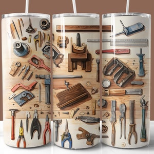 May include: A stainless steel tumbler featuring a watercolor illustration of various woodworking tools arranged on a wooden surface. The design includes hammers, pliers, saws, and other carpentry instruments in shades of brown, gray, and blue.