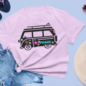 May include: A pink t-shirt with a black silhouette of a vintage van with the word "PEACE" on the side. The van has a surfboard on top and flowers on the side.