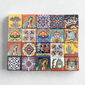 May include: A collection of 20 square ceramic tiles with colourful, hand-painted designs. The tiles feature images of religious figures, floral patterns, Day of the Dead skulls, and Mexican cultural motifs. Each tile is approximately 10 cm square.