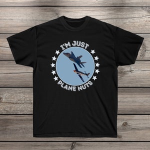 May include: Black t-shirt with a white circle graphic featuring two airplanes and the text "I'm Just Plane Nuts" surrounded by white stars.