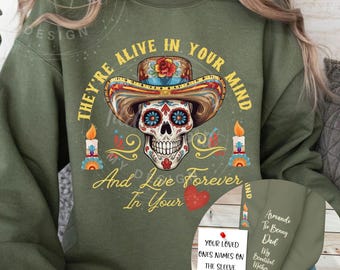 May include: Green sweatshirt with a colorful sugar skull design and the text "They're alive in your mind and live forever in your heart".