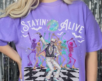 Stayin Alive Roller Skate Disco Skeletons Halloween Humor Unisex Comfort T-shirt Colorful Seventies Disco Ball Era Vibe Novelty Crewneck Tee