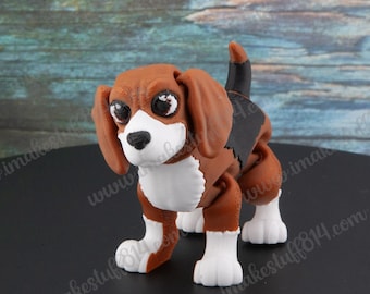 May include: A brown and white beagle figurine with black ears and a brown tail. The figurine is standing on a black surface.