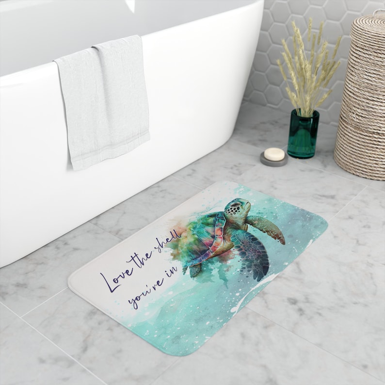 May include: A bathroom rug with a watercolor design of a sea turtle with the text "Love the shell you're in".