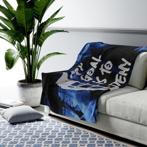 May include: A blue and black throw blanket with a white graphic that says "My goal is to deny".