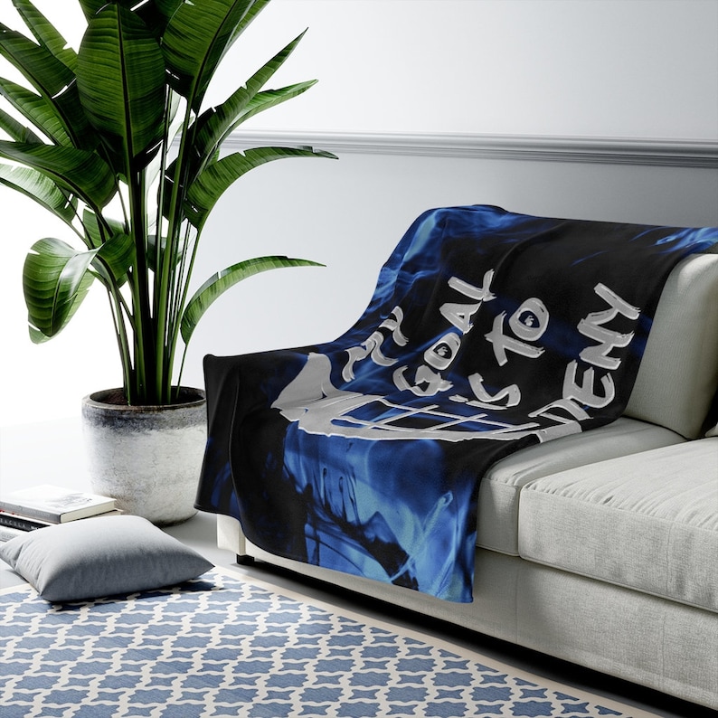 May include: A blue and black throw blanket with a white graphic that says "My goal is to deny".