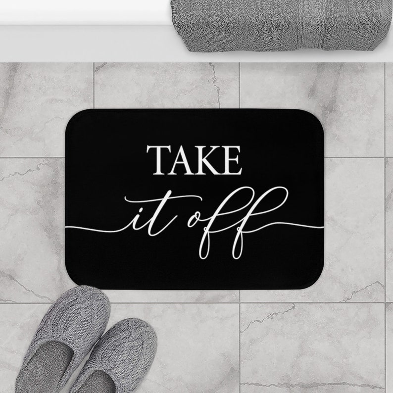 May include: Black bath mat with white text that says "Take it off".