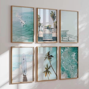 May include: Set of six framed prints with a beach theme. The prints feature a surfboard, palm trees, a vintage van, a lifeguard stand, and ocean waves.