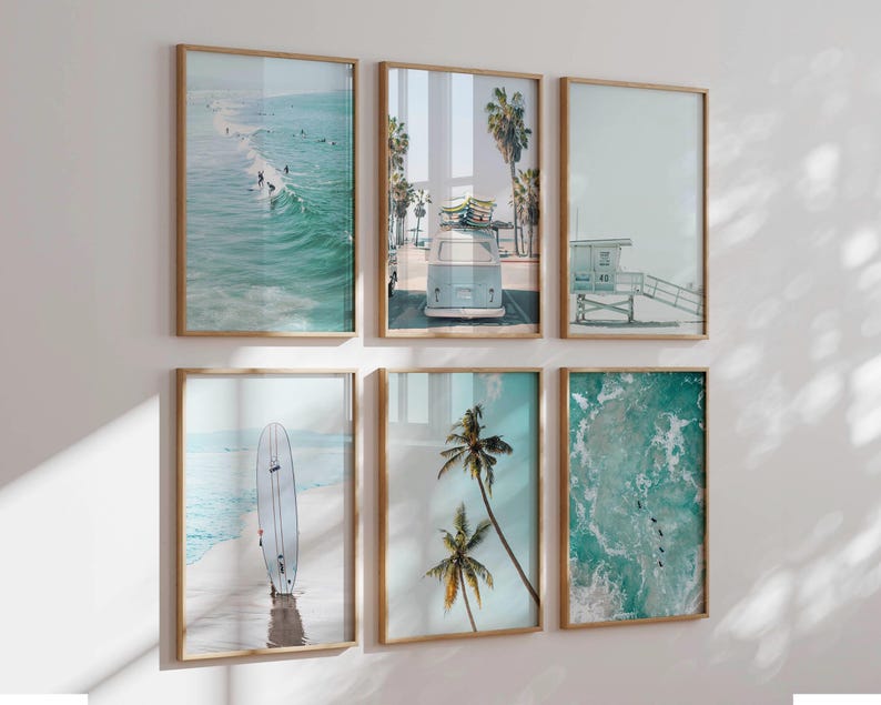 May include: Set of six framed prints with a beach theme. The prints feature a surfboard, palm trees, a vintage van, a lifeguard stand, and ocean waves.