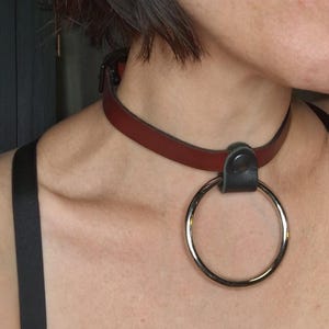 The Chome Ruby. Ruby Red Leather Collar. 2" silver O-ring, solid brass. Black buckle closure. Handmade.