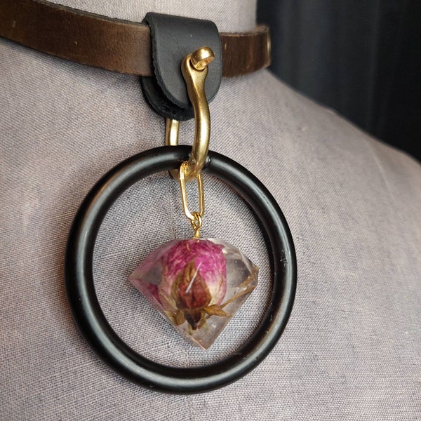 Rose & O-ring statement piece collar. Pink rosebud cast in jewel shaped  pendant hangs from a gold plated shackle pin and leather collar.