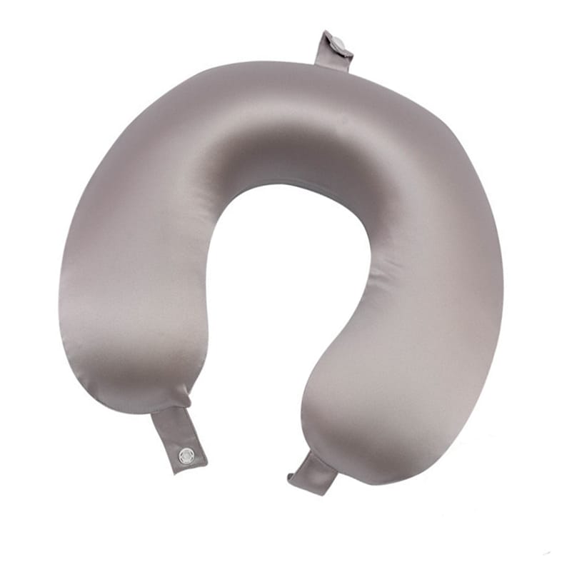 May include: A gray travel neck pillow made of soft, silky material. The pillow has a U-shape and two adjustable straps with buttons.