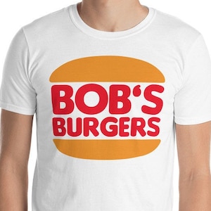 May include: White t-shirt with a red and yellow graphic of a hamburger with the text "BOB'S BURGERS" on it.