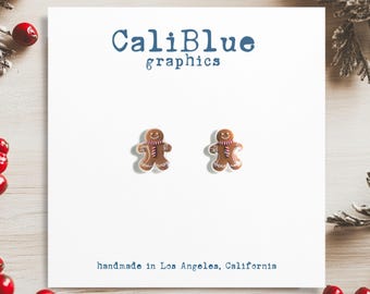 May include: A pair of gingerbread man stud earrings on a white card with the text "CaliBlue graphics" and "handmade in Los Angeles, California".