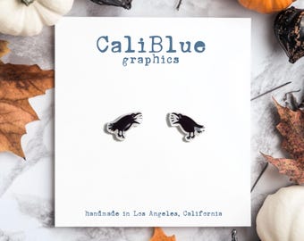 May include: A pair of black crow earrings on a white card with the text "CaliBlue graphics" and "handmade in Los Angeles, California".