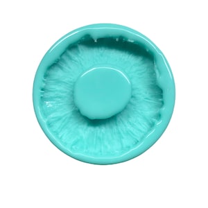 May include: A turquoise blue silicone mold shaped like a mushroom. The mold has a detailed texture and a smooth, rounded top.