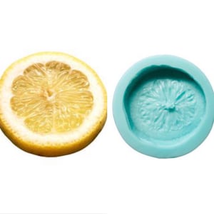 May include: A silicone mold for baking in the shape of a lemon slice. The mold is blue and the lemon slice is yellow.