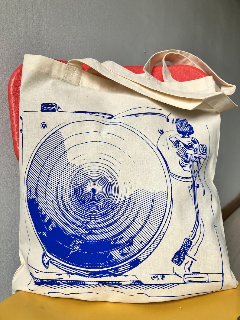 https://www.etsy.com/listing/1805262270/gift-for-record-collector-vinyl-music

record tote bag
vinyl lover gift
dj gift idea
music tote bag
screenprinted tote
musician gift
vinyl record bag
music fan tote
canvas tote for records
record store shopper
hand printed tote
cool music gifts
turntable tote bag