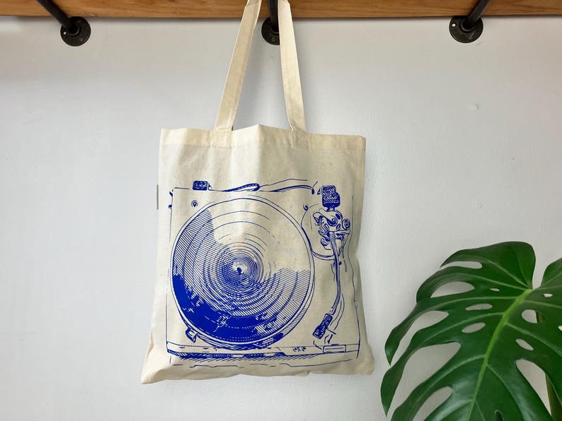 https://www.etsy.com/listing/1805262270/gift-for-record-collector-vinyl-music

record tote bag
vinyl lover gift
dj gift idea
music tote bag
screenprinted tote
musician gift
vinyl record bag
music fan tote
canvas tote for records
record store shopper
hand printed tote
cool music gifts
turntable tote bag