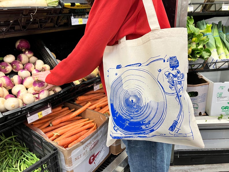 https://www.etsy.com/listing/1805262270/gift-for-record-collector-vinyl-music

record tote bag
vinyl lover gift
dj gift idea
music tote bag
screenprinted tote
musician gift
vinyl record bag
music fan tote
canvas tote for records
record store shopper
hand printed tote
cool music gifts
turntable tote bag
