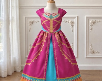 May include: A floor-length dress featuring a vibrant magenta bodice and skirt with short sleeves. The garment is accented with gold-toned trim, intricate patterns, and a bright turquoise central panel. The design includes a sweetheart neckline and a flared silhouette with a decorative border along the hemline.