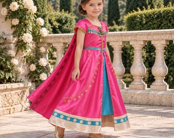 May include: A floor-length fuchsia dress with short sleeves, a blue underskirt, and a long attached cape. The bodice features gold trim and a central blue band, while the skirt is decorated with gold circular patterns and a wide blue hem.